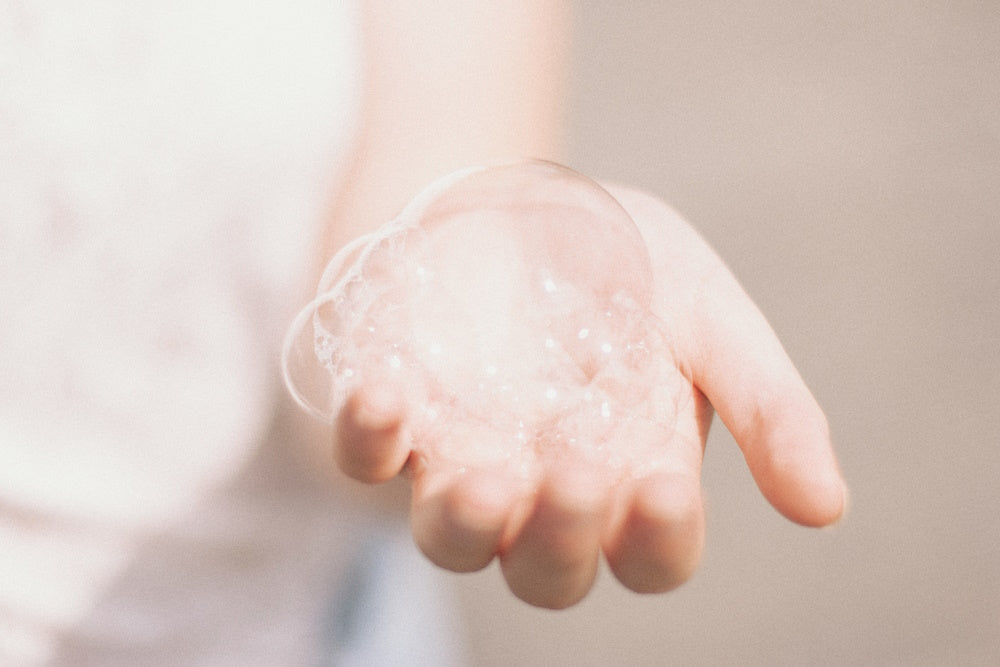 man holding soap bubbles